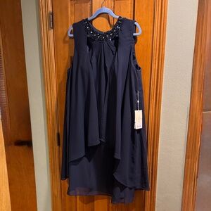 Sleeveless Navy dress with beaded neckline.
